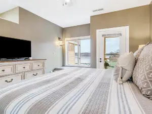Serene waterfront condo with W/D, patio, & electric grill - boat slip on lake