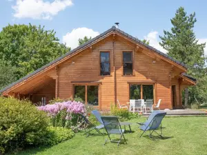 Wooden House in a green setting.
