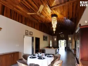 StayVista at Riverfront Cottage with Scenic River view, BBQ, Bonfire, Gazebo, Pet friendly