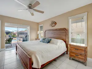 Stylish waterfront home with private pool, canal access, patio, grill, & AC