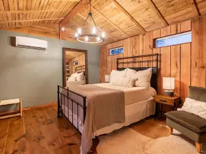 Cabin Just Built! features two covered decks, living room, fireplace, kitchen