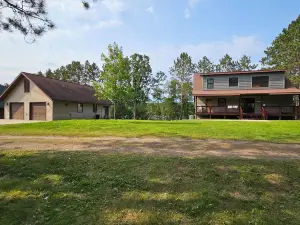 Three bedroom hide-a-way with spacious deck over looking Island Lake.