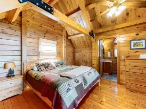 Dog-friendly lakefront cabin with covered porch & firepit on the shore