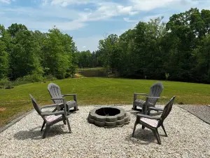 Cozy cabin on 16.5 acres with a stocked fishing pond. Close to Charlotte.