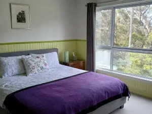 cosy cottage with wood heater, surrounded by bushland