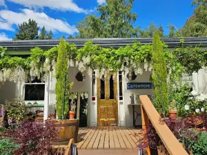 Cozy, beautifully decorated cottage sitting in a stunning seasonal garden