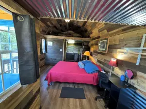 The Little Sugar Shack, a rustic tiny cabin with hot tub access & fiery sunsets!