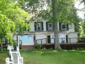 Gorgeous Sandy Beachfront Paw Paw lake home with 155 ft. of frontage and dock
