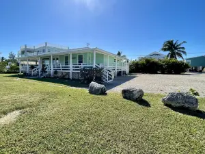 Old Florida Style, wrap around porch, boat basin for dockage, open water