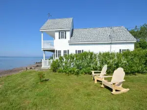 Sea-Breeze Cottage perched on the edge of the bay.