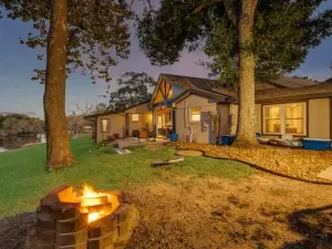 Riverfront estate with outdoor fireplace, bbq, river deck, boat dock and more!