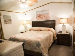 Lake front retreat, covered boat dock, large deck , fenced play area, RV parking