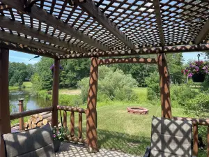 Ausable River waterfront 4-bed house in Grayling w/dock, patio, firepit, garage.