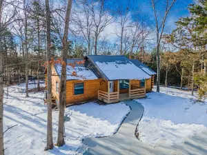 New 3 Bedroom Log Cabin nestled in the woods with one acre fishing lake .