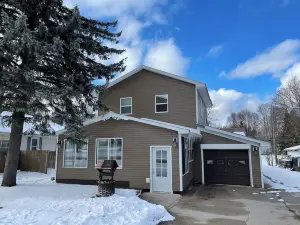 Spacious 4-bedroom home with atv/snowmobile trail across the street. Come UP!