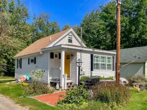 Quintessential lakeside cottage with dock access, picnic tables, & mountain view