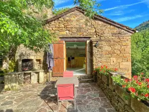 In a fantastic medieval village, house in stone with a nice view near the river