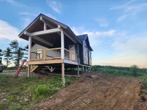 Small cottage house, centered on 100 acres surround by hills, lake, and cattle.