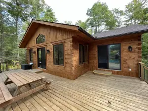 Timber cottage with large deck overlooking the water. Boat access only, no road.