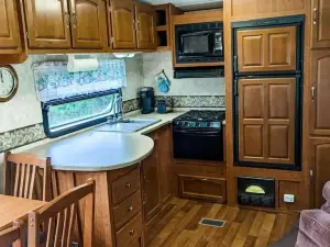 Camper in middle of farm setting with creek view