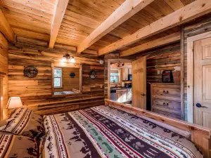 Waterfront cabin with bridge, private hot tub, & WiFi - near National Forest