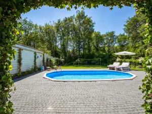 A Detached Bungalow with Outdoor Fireplace Covered Terrace and Pond in a Forest Plot