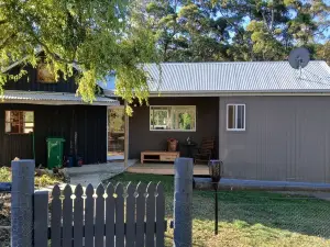 cosy cottage with wood heater, surrounded by bushland