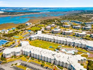 Ocean-view condo with beach access, pool, sports courts, & private balcony