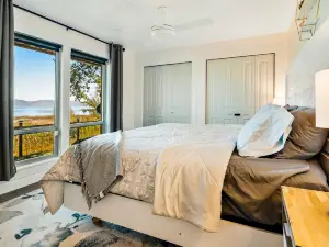 Single-level, lakefront getaway with mini-bar, furnished deck & mountain views