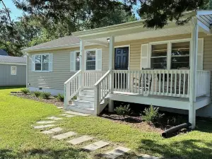 Walk to town from this cozy Rivah house with awesome yard and water views.