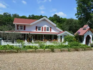 Restored Historical Farmhouse With Pond And Farm Animals At Mohican State Park