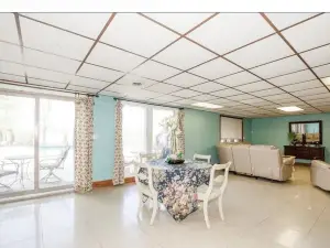 A MANSION WITH A HUGE INDOOR HEATED SWIMMING POOL WITH A BONUS THEATER ROOM.