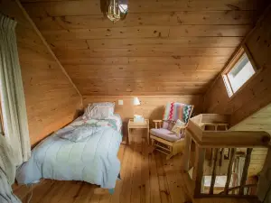Spiral Staircase Leads To The Lofted Bedroom And Overlooks The Birch Woods.