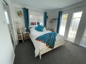 Newly finished self-contained unit above Arkles Bay watch sunset over Auckland