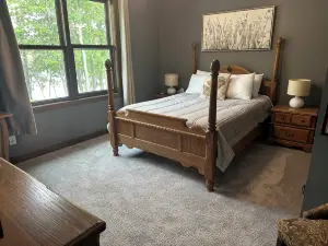 BEAUTIFUL lake front home with a private beach, dock and large yard